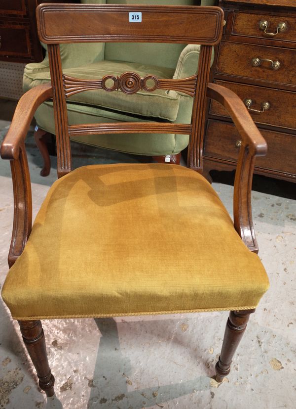 A set of four Regency mahogany bar back dining chairs to include one carver, (4).