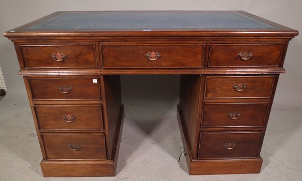 An early 20th century mahogany pedestal desk with tooled faux blue leather inset top, 124cm wide x 78cm high.