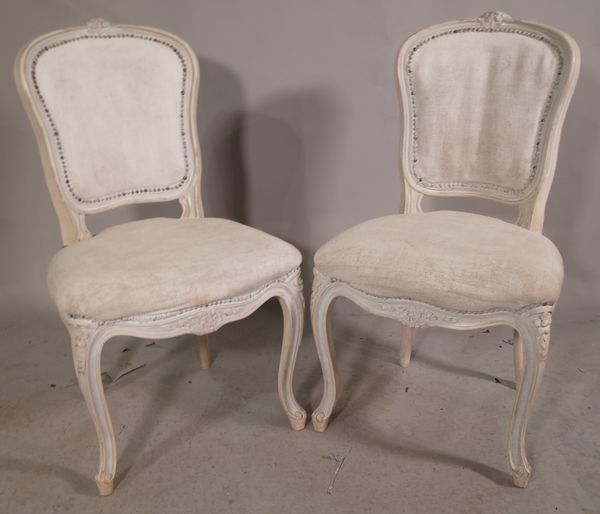 A pair of Louis XV style white painted dining chairs on cabriole supports, (2).