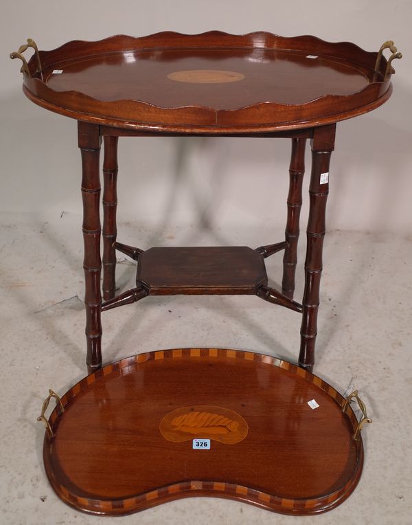 An Edwardian mahogany and satinwood inlaid kidney shaped galleried tray, 56cm wide and another Edwardian galleried tray on later added stand, 60cm wid