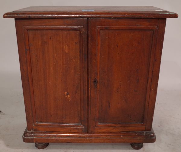 An early 20th century hardwood collectors chest with cupboard doors and four drawers, 44cm wide x 43cm high.