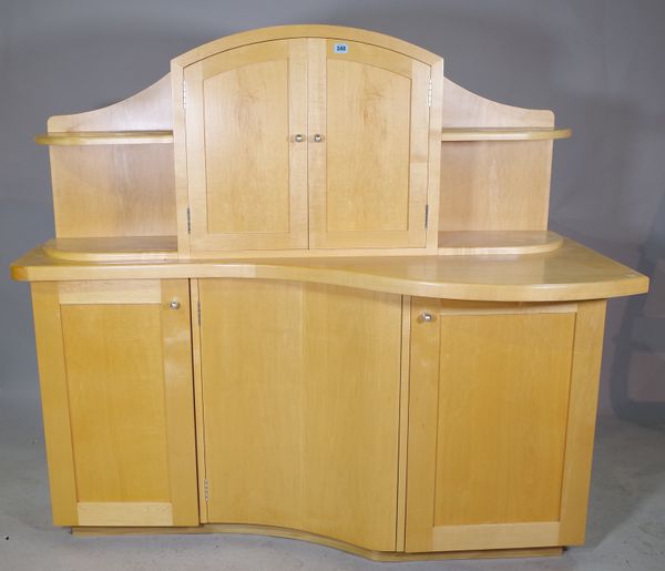 A 20th century beech side cabinet of asymmetric form, 150cm wide x 137cm high.