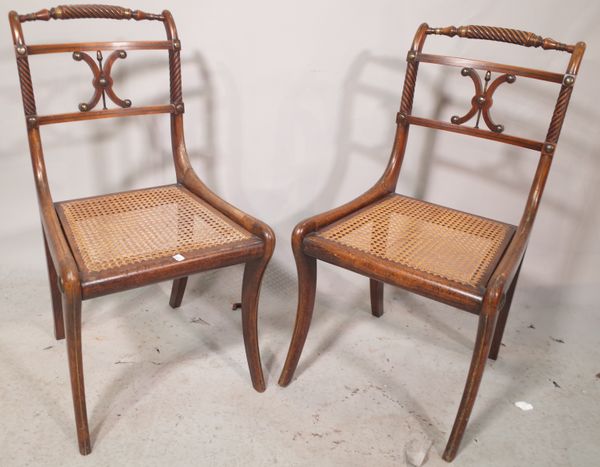 A set of four Regency faux rosewood side chairs on sabre supports, (4).