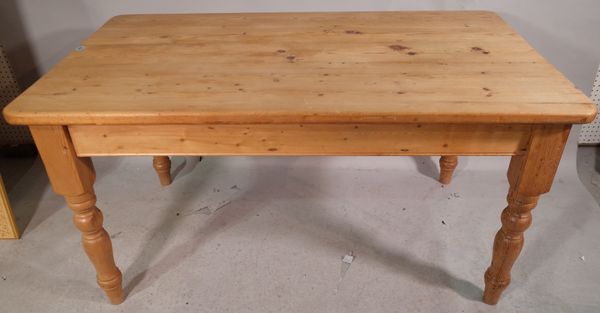 A pine rectangular kitchen table with single frieze drawer on turned supports, 90cm wide x 153cm long.