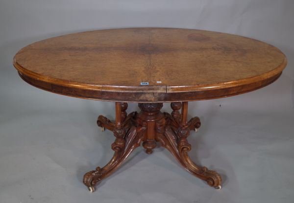 A Victorian burr walnut oval snap top dining table on four out swept support, (a.f.).