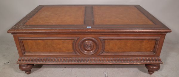 A Regency style mahogany coffee table, with tooled tan leather top over two drawers on bun feet, 128cm wide x 50cm high.