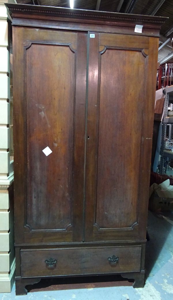 A George III style mahogany double wardrobe, panelled doors over single drawer on bracket feet, 105cm wide x 200cm high.