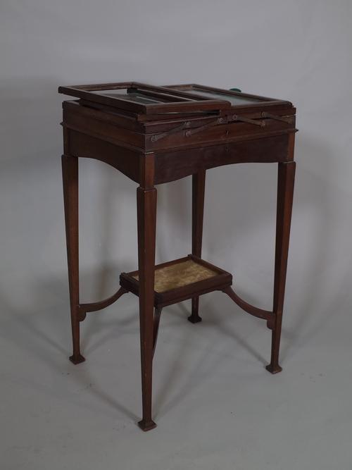An unusual Edwardian mahogany fold out bijouterie table, (a.f).