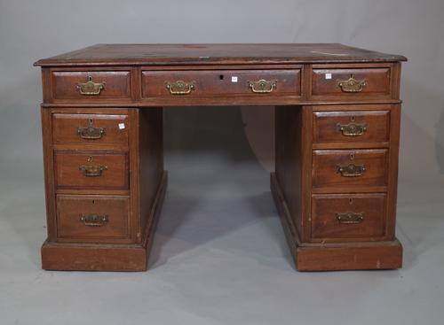 An early 20th century mahogany pedestal desk with tooled red leather top, 120cm wide x 70cm high.