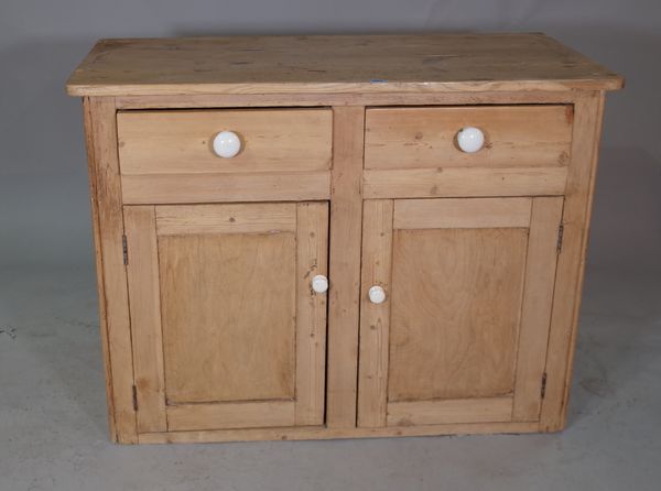 An early 20th century pine dresser base with two drawers over cupboard base, 113cm wide x 86cm high.