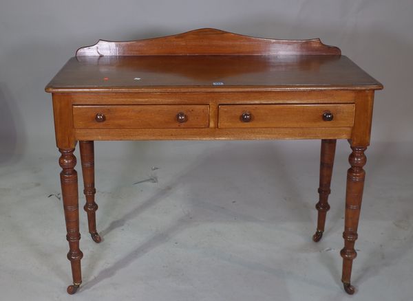 A Victorian mahogany two drawer side table,  with galleried back on ring turned supports.