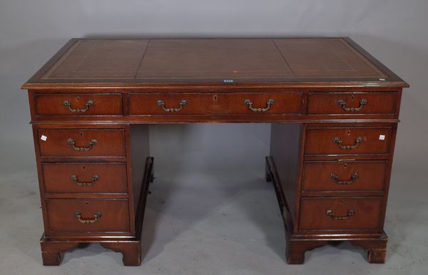 A 20th century mahogany pedestal desk, with tooled brown leather top, 136cm wide x 80cm high.