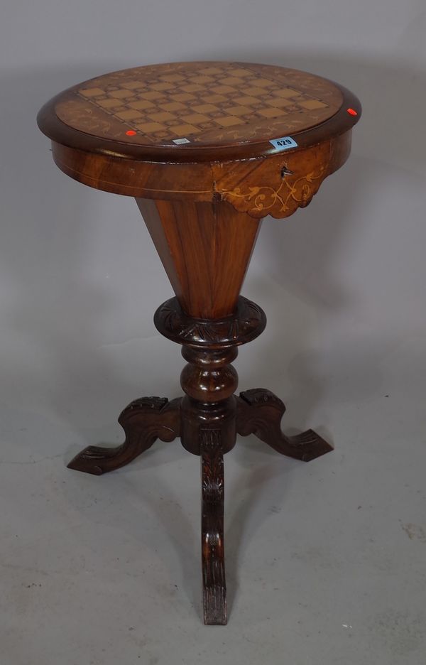 A late Victorian mahogany and satinwood inlaid circular games/sewing table on three downswept supports, 47cm wide x 74cm high.