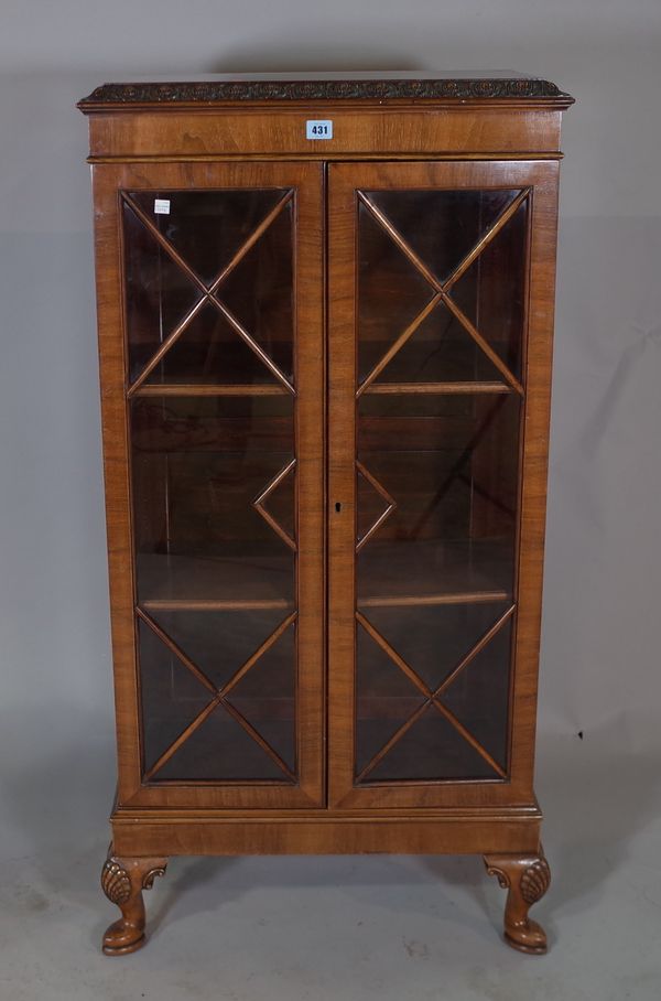 A George III style mahogany bookcase on shell capped cabriole supports 61cm wide x 123cm high.