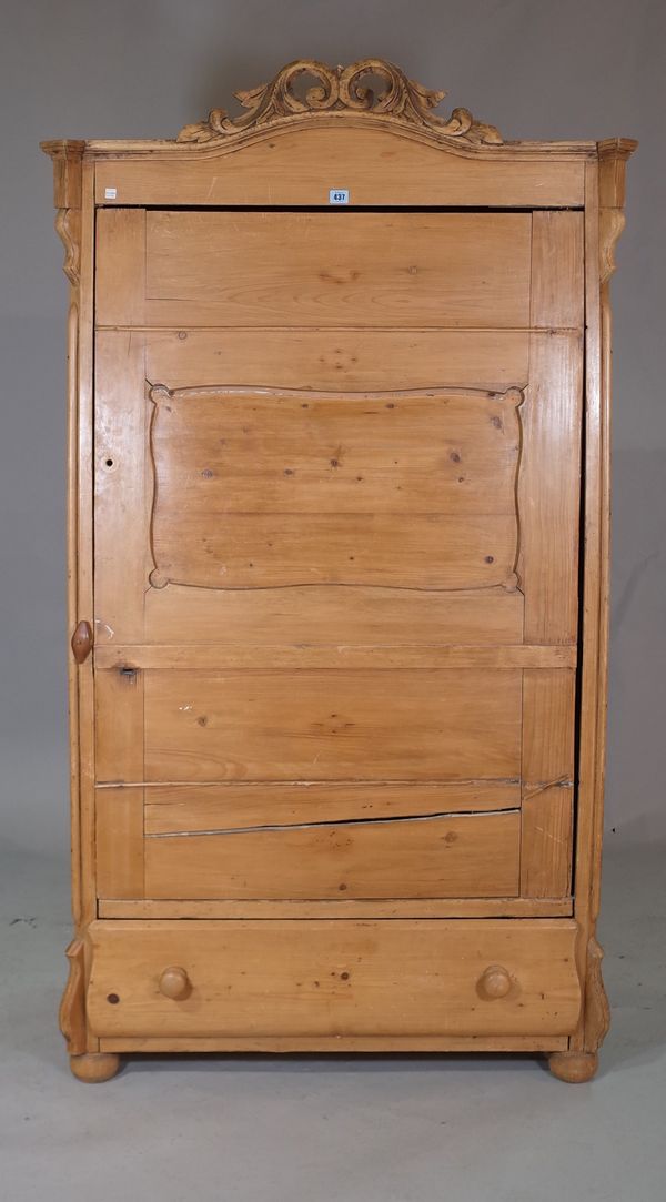 An early 20th century arch top pine single door wardrobe, with single drawer to base on bun feet, 102cm wide x 180cm wide.