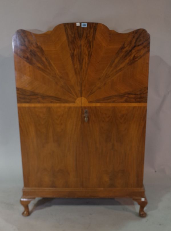 A mid-20th century walnut arch top side cabinet, with specimen wood veneered sunburst front on cabriole supports, 80cm wide x 133cm high.