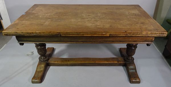 An 18th century style oak draw leaf dining table on turned bulbous carved supports, united by stretcher, 153cm long x 78cm high x 259cm fully extended