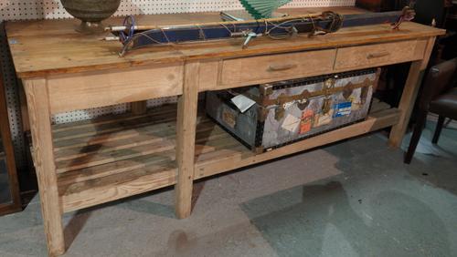 An early 20th century pine preparation table with two drawers, 239cm wide x 83cm high.