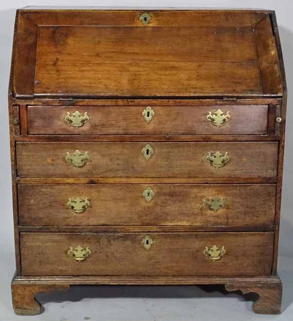 An 18th century and later oak bureau of four long graduated drawers on ogee bracket feet, 92cm wide x 104cm high.