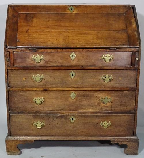 An 18th century and later oak bureau of four long graduated drawers on ogee bracket feet, 92cm wide x 104cm high.