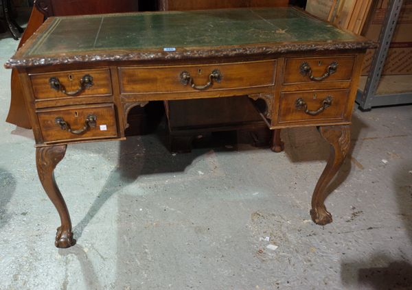 A mid-18th century style writing desk, the serpentine leather inset top over five frieze drawers, on claw and ball feet, 107cm wide x 73cm high.