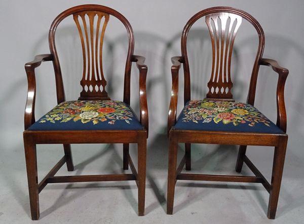 A pair of Hepplewhite design mahogany arch back carver chairs on tapering square supports, 56cm wide x 96cm high.