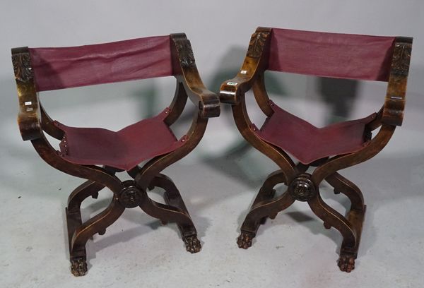 A pair of 20th century Savonarola chairs with maroon leather upholstery, 58cm wide x 69cm high.