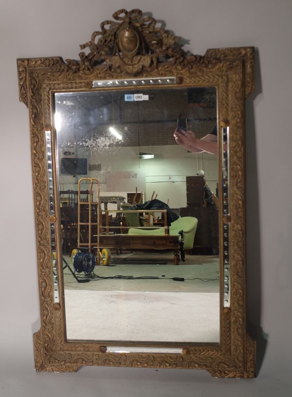 A 19th century French gilt framed mirror with cartouche crest and out stepped square corners, 85cm wide x 134cm high.