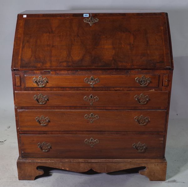 A late George III walnut and mixed wood bureau with fitted and welled interior, over four long graduated drawers on shaped bracket feet, 91cm wide x 1