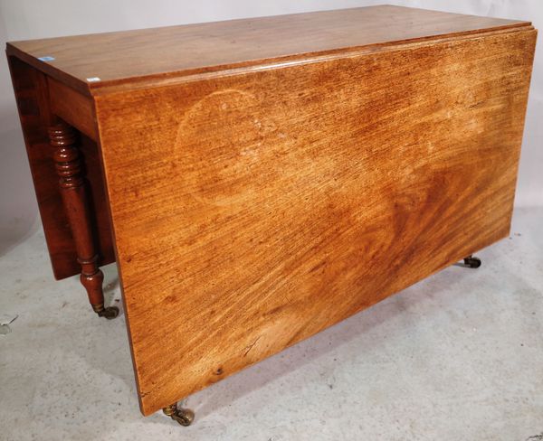 An early Victorian mahogany drop flap dining table on ring turned tapering supports 179cm long x 114cm wide x 72cm high.