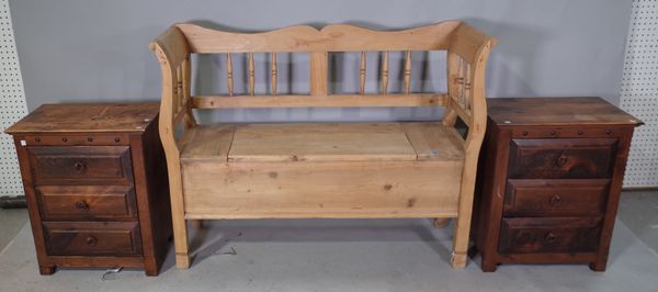 A 20th century pine settle with lift top base, 119cm wide x 90cm high ad a a pair of 20th century stained pine three drawer bedside chests, 51cm wide