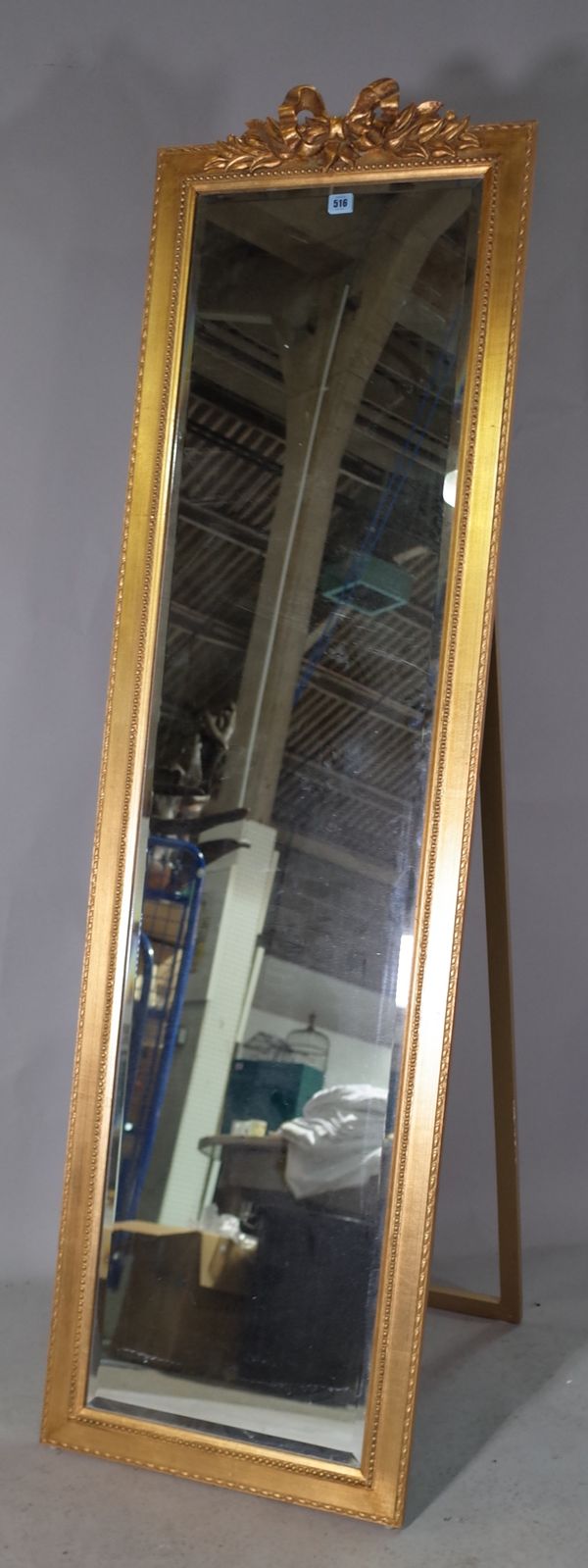 A 20th century gold painted floor standing dressing mirror with ribbon tied crest, 51cm wide x 177cm high and a 20th century gold painted rectangular