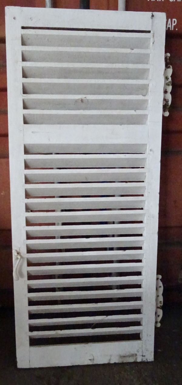 A set of four early 20th century white painted slatted shutter doors with butterfly hinges, 71cm wide x 172cm high< (4).