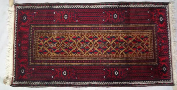 An Afghan rug, 184cm x 113cm and two Beluchi rugs, 136cm x 77cm, 175cm x 92cm, (3).