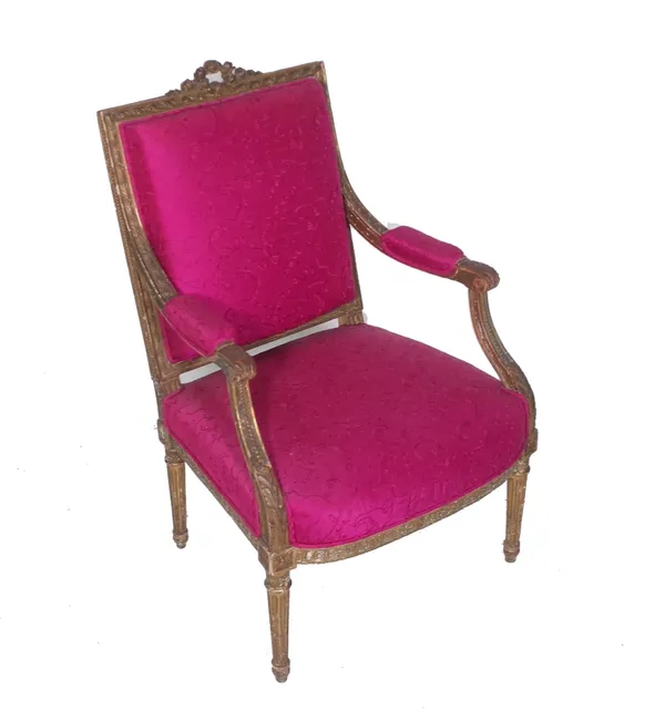 A Louis XVI style giltwood open arm fauteuil, with pink upholstery.  Provenance; property from the late Sir David TangThis lot has been imported from