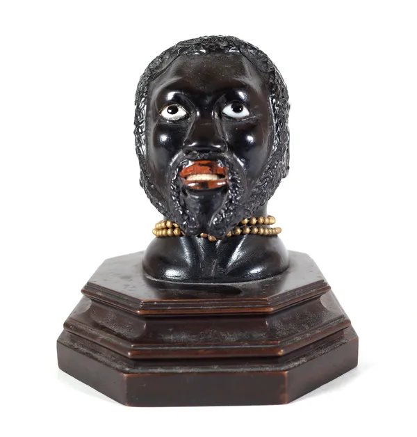 An early 20th century hardwood carved figural inkwell, pre-1918, modelled as a Nubian man, 14cm wide x 117cm high. Provenance; property from the late