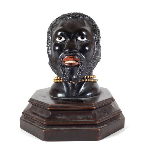 An early 20th century hardwood carved figural inkwell, pre-1918, modelled as a Nubian man, 14cm wide x 117cm high. Provenance; property from the late