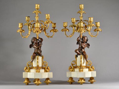 In the manner of Henry Dasson, a pair of French bronze, ormolu and white marble six branch figural candelabra, late 19th century, the central cupid fi