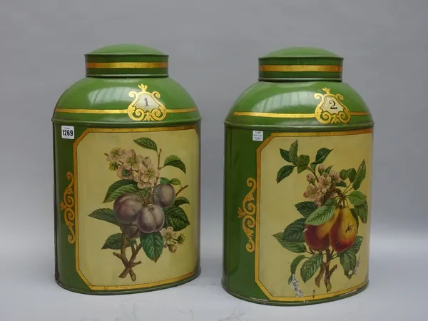 A pair of tole peinte tea canisters and covers, mid-20th century, fruit and gilt painted decoration against a green oval body, numbers 1 &2, Harrods l