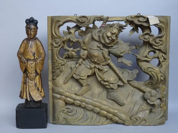 A Chinese giltwood panel, 20th century, relief carved with a warrior figure, 64cm x 58cm x 8cm, and a Chinese giltwood carved figure, 57cm high. (2)