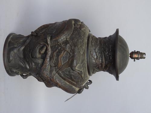 A Japanese mixed metal vase, relief cast with dragon chasing a flaming pearl, later converted to a table lamp base, 50cm high.