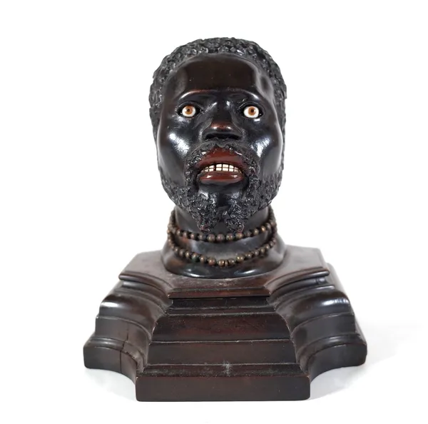 An early 20th century hardwood carved figural inkwell, pre-1918, modelled as a Nubian man, 14cm wide x 17cm high.  Provenance; property from the late