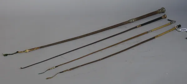 A French gold mounted riding whip, late 19th century, with foliate embossed decoration, 84cm, a silver mounted riding whip and two further whips. (4)