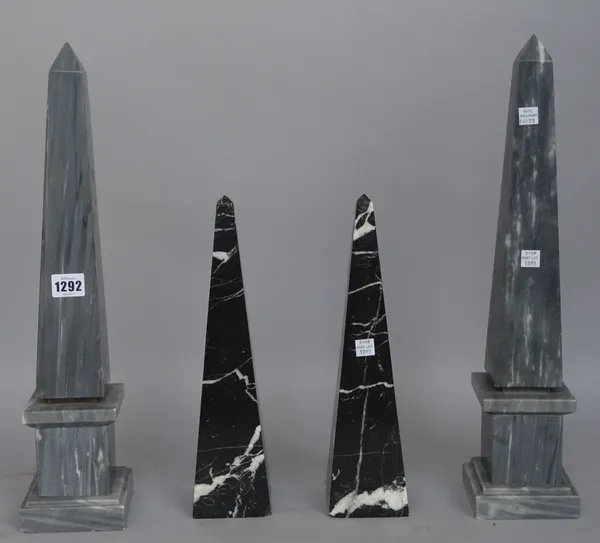 A pair of grey marble obelisks, raised on a stepped square plinth and a pair of smaller black marble obelisks with white vein inclusions, 32cm high, (