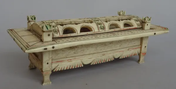 A Napoleonic prisoner-of-war bone dominoes casket with polychrome figural decoration to the sliding lid, 18.2cm wide.