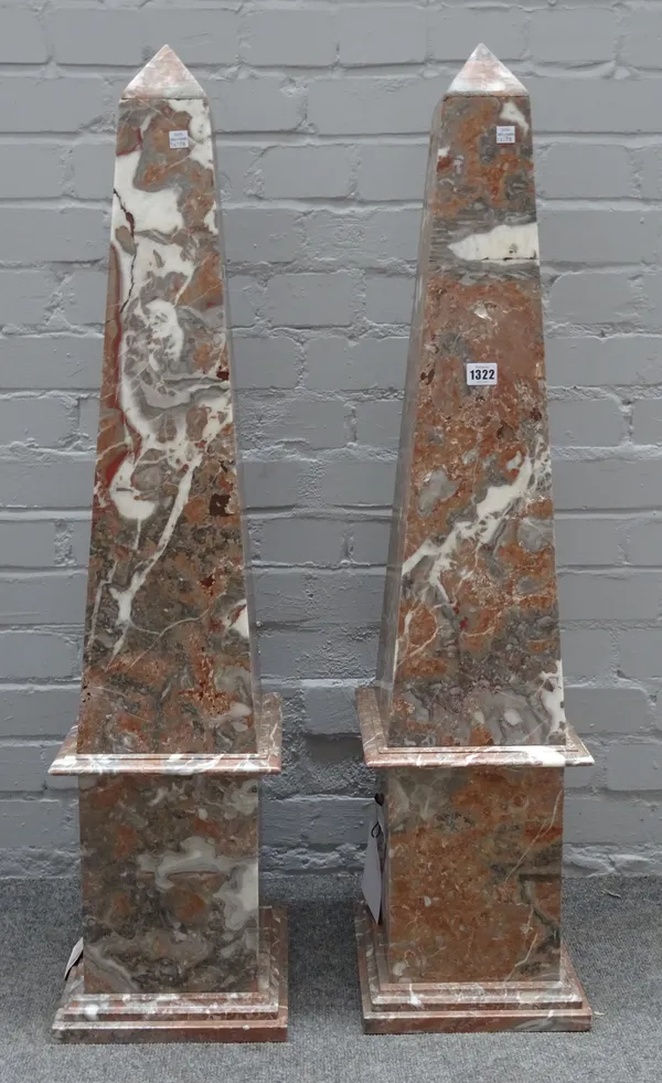 A pair of large rouge marble obelisks, on stepped plinth bases, 104cm high, (2).