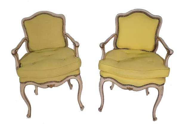 A pair of Louis XV style parcel gilt fauteuils on cabriole supports. (2) Provenance; property from the late Sir David Tang This lot has been imported