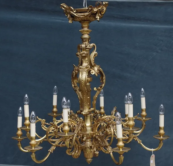 A French ormolu twelve light chandelier, Louis XVI style, the reeded stem with ornate foliate embellishments issuing twelve branches semi-graduated ov