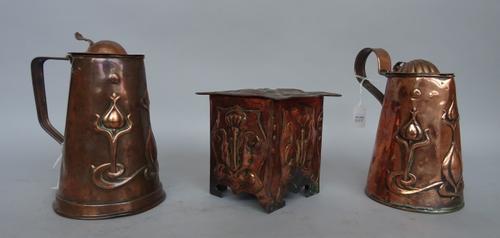 An Art Nouveau Newlyn style lidded jug stamped J.S & S to the base, 19.5cm high, another similar smaller jug and an Art Nouveau copper string box of s