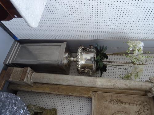 A pair of modern nickel plated metal urns each containing faux orchids, raised on nickel plated square plinths, 134cm high overall not including 'plan